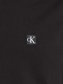 Polo en coton noir uni avec un col boutonné et une coupe droite