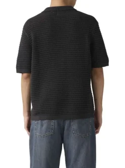 Polo en coton noir uni avec une coupe droite et un col boutonné
