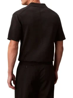 Polo en coton noir uni à coupe légèrement oversize avec le logo brodé