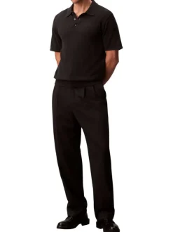 Polo en coton noir uni à coupe légèrement oversize avec le logo brodé