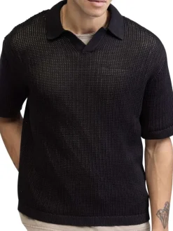 Polo en coton noir uni en maille ajourée avec une coupe droite