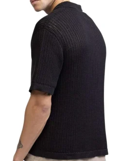 Polo en coton noir uni en maille ajourée avec une coupe droite