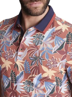 Polo en coton orange fleuri à coupe slim fit et à col fermé par trois boutons