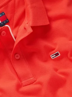 Polo en coton régénératif orange uni avec une coupe droite, col boutonné et logo