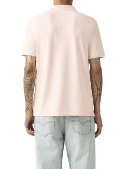 Polo en coton rose uni avec une coupe droite et un col boutonné