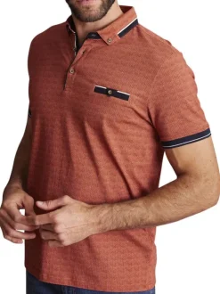 Polo en coton rouille à imprimé minis pois bleus marine et à coupe slim