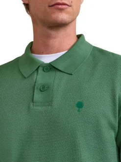 Polo en coton vert uni avec un logo brodé et un col boutonné