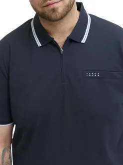 Polo marine uni avec une coupe droite, un col zippé et des manches courtes