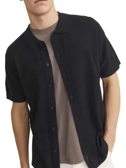 Polo noir uni coupe droite col français et des manches courtes