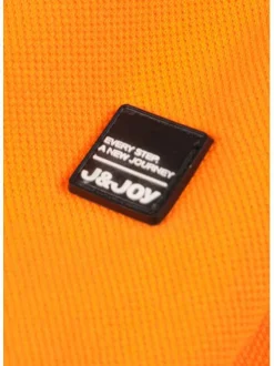 Polo orange en coton maille piquée avec nombreux détails coupe droite col boutonné