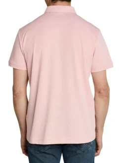Polo rose uni pourvu de manches courtes et d'un col boutonné