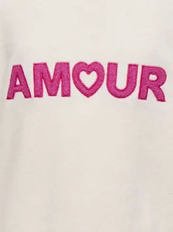 Pull écru uni pourvu de manches longues et d'une coupe droite