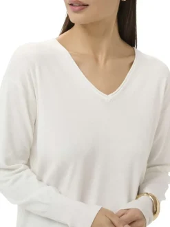 Pull blanc uni pourvu d'une coupe droite et de manches longues