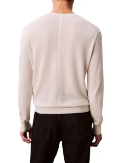 Pull en coton écru uni avec un col rond et des manches longues