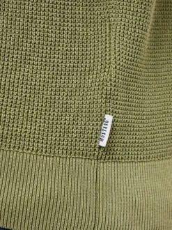Pull en coton kaki uni avec une coupe droite et un col rond