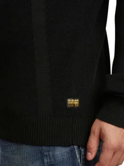 Pull en coton noir uni avec une coupe droite et un col camionneur