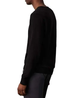 Pull en coton noir uni avec une coupe droite un col rond et le logo en petit