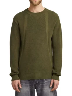 Pull en coton vert uni avec un col rond et un patch d'authenticité
