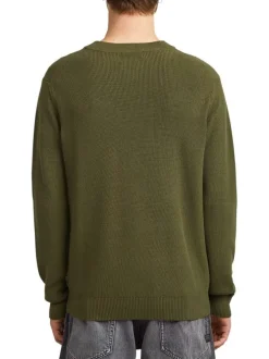 Pull en coton vert uni avec un col rond et un patch d'authenticité