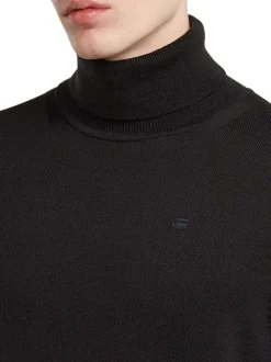 Pull en laine noir uni avec une coupe droite et logo iconique