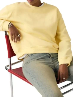 Pull jaune à coupe droite pourvu d'un col rond et de manches longues