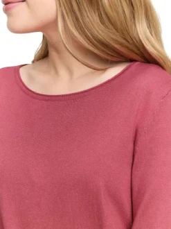 Pull rose uni avec une coupe ajustée et des manches longues moulantes