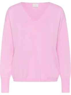 Pull rose uni pourvu d'une coupe droite et de manches longues