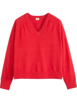 Pull rouge moucheté avec un col v côtelé et des manches longues
