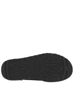 Sabots en cuir noir à talon plat et à slip-on avec de la fourrure synthétique