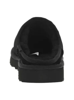 Sabots en cuir noir à talon plat et à slip-on avec de la fourrure synthétique
