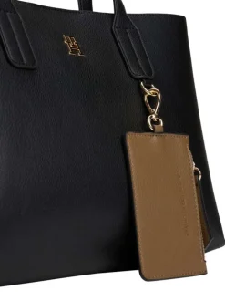Sac à main noir pourvu d'une bandoulière amovible et d'un bouton à pression