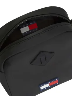 Sacoche noire unie avec une bandoulière ajustable et fermeture à zip