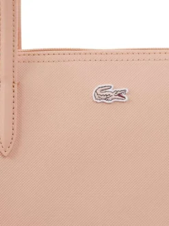 Sac shopping rose pourvu d'une fermeture zippée et du logo de la marque