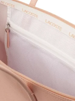 Sac shopping rose pourvu d'une fermeture zippée et du logo de la marque