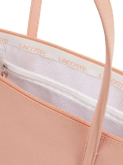 Sac shopping saumon pourvu d'une fermeture zippée et du logo de la marque