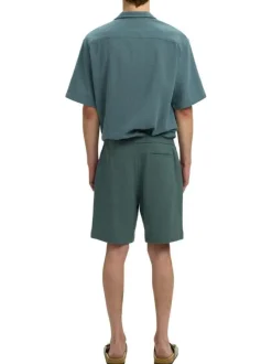 Short en coton vert uni pourvu d'une taille élastiquée et d'une coupe droite