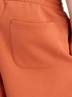 Short jogging orange uni avec une coupe droite et une taille élastique