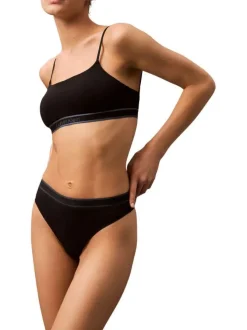String noir uni avec une taille élastiquée et des liserés sur le haut