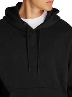 Sweat à capuche en coton noir avec une coupe droite et un imprimé au dos