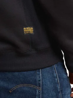 Sweat à capuche en coton noir uni avec une coupe droite et une poche