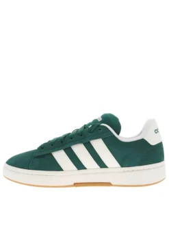 Tennis vertes et blanches à talon plat avec des lacets larges
