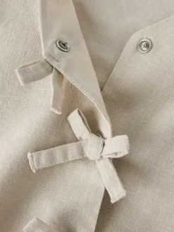 Top en coton biologique beige uni pourvu d'une coupe droite et d'un col v