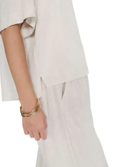 Top beige uni fluide avec une coupe large et des manches courtes