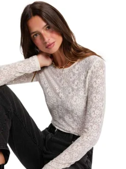 Top écru avec broderie florale avec une coupe moulante et un col rond