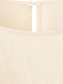 Top en lin beige uni pourvu d'une coupe droite et de manches longues