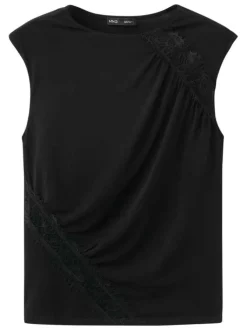 Top noir uni avec une coupe ajustée et des empiècements en dentelle