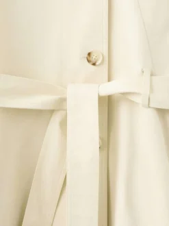 Trench coat long en coton beige uni avec une coupe ample et un col montant