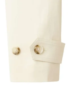Trench coat long en coton beige uni avec une coupe ample et un col montant