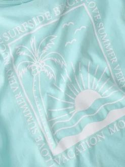 T-shirt en coton biologique ciel uni pourvu d'un imprimé soleil