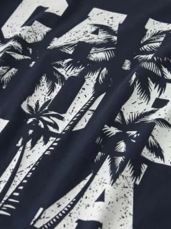 T-shirt en coton biologique marine uni pourvu d'un imprimé palmier